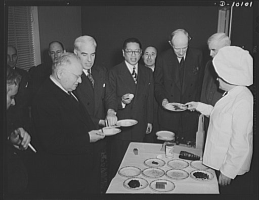 Guests at luncheon celebrating second anniversary of lend-lease, on March 11, 1943, at Hotel Statler, Washington, D.C., examine dehydrated food which was served. Left to right: Maxim Litvinov, ambassador of Russia; Edward R. Stettinius, Jr., lend-lease administrator; Dr. T.V. Soong, Chinese foreign 