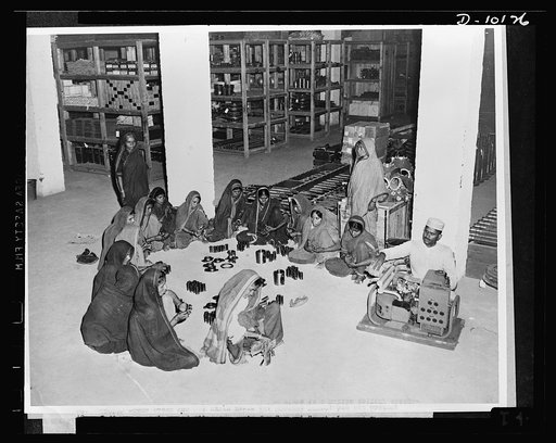 Woman power in India. Indian cleaning and oiling spare parts for tanks supplied under lend-lease