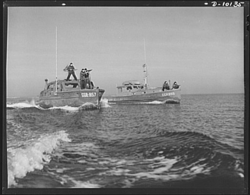 Coast Guard Auxiliary. Guardians of inland waters. Designated by the initials of the Coast Guard Reserves, these cabin cruisers have been made available to the government for the duration by their owners. A temporary reservist serves as helmsman for each of the boats while regular Coast Guardsmen ma
