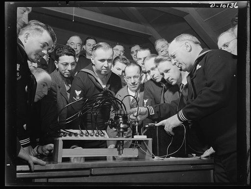 Coast Guard Auxiliary. Guardians of inland waters. Coast Guard Auxiliary members meet once a week for instruction. Here Harry Whitten, a Boston automobile distributor (right) gives instructions to fellow reservists in the workings of the ignition system of a marine engine