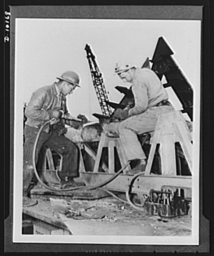Rushing the SS George Washington Carver to completion. Negro skilled workers played an important part in the construction of the SS George Washington Carver, second Liberty Ship named for a Negro, in the Richmond Shipyard No. 1 of the Kaiser Company. Looking over the plans of the shipyard are, left 