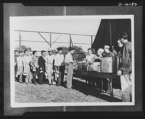 Japanese-American volunteers. A typical army scene--waiting in line for dinner. First of the territory's AJA [Americans of Japanese ancestry] volunteers to take their physical exams, these Kauai, Hawaii men were quartered in a provisional camp pending annoucement of results of final tests. Here they