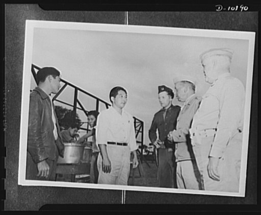 Japanese-American volunteers. Recognized among the AJA [Americans of Japanese ancestry] inductees by Major General Rapp Brush, commanding the Kauai District. Masato Sugihara, thirty-one, Kekaha school teacher, speaks with the general in the course of the latter's unexpected inspection of the provisi