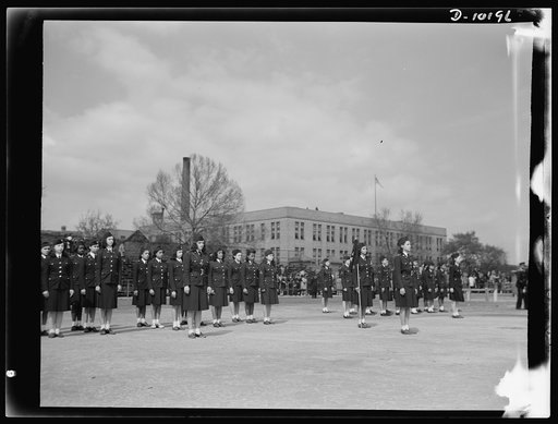 Women's Army Auxiliary Corps officers review girl cadets. In competitive drill contest among the girl cadets at Dunbar High School, Washington, D.C., Company C, under command of Captain Crystal Malone, was adjudged the best of three companies by a distinguished group of judges which included Lieuten