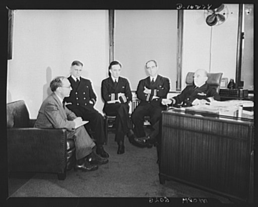 New York, New York. Editor Griswold of the Office of Production Management (OPM) News meeting with Navy officials. They are, left to right: Lieutenant Commander E.U. Rinehart, U.S. Naval Reserve, senior naval adviser of the Third Naval District; Commander J.B. Goode, senior assistant to the Inspecto