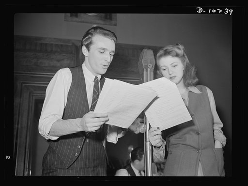"You Can't Do Business With Hitler." Rehearsing for the radio show "You Can't Do Business With Hitler" are John Flynn and Virginia Moore. This series of programs, broadcast at least once weekly by more than 790 radio stations in America, is written and produced by the radio section of the Office of 