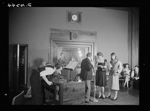 "You Can't Do Business With Hitler." Rehearsal is underway for "You Can't Do Business With Hitler,"  the radio show written and produced by the radio section of the Office of War Information (OWI). At the microphone are (left to right) Colonel Charles Ferris, Doris McWhirt, Virginia Moore. In the co