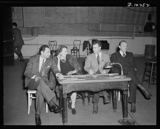 Jack Schaindlin, musical director, Eleanor Herring, Philip Martin, Jr., technical director, Max Brasch, film editor,  at the Long Island Studios of the Army Signal Corps for the recording of Spencer Tracy's narration of the "Ring of Steel," an Office of Emergency Management (OEM) film, on February 1