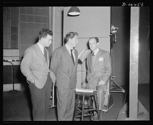Philip Martin, Jr., technical director, Spencer Tracy, narrator and Garson Kanin, director, at the Long Island Studios of the Army Signal Corps for the recording of Spencer Tracy's narration of the "Ring of Steel," an Office of Emergency Management (OEM), film on on February 19th, 1942