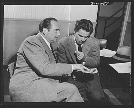 Three Thirds of the Nation. Edward Arnold and Glen Ford, stars on War Production Board (WPB) radio program Steel, presented May 6 over Blue Network, look over script during lull in rehersal