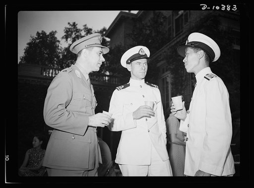 The uniforms are different but the cause is the same. Officers of the United Nations attend a garden party of the United Nations Club at Dumbarton Oaks, Sunday, September 6, 1942. Left to right: Lieutenant W. Van der Weyde, Royal Netherlands Army Reserve; Lieutenant L. R. Lund, Norway Navy; Lieutena