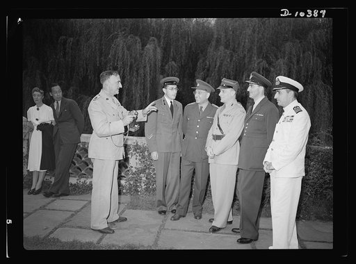 The uniforms are different but the cause is the same. Officers of the United Nations attend a garden party of the United Nations Club at Dumbarton Oaks, Sunday, September 6, 1942. Left to right: Lieutenant Colonel Sutton, Australia; Major Barayev, Assistant Military Attache, Russian Embassy; Colonel