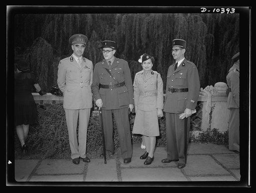 The uniforms are different but the cause is the same. Officers of the United Nations attend a garden party of the United Nations Club at Dumbarton Oaks, Sunday, September 6, 1942. Left to right: Colonel B. E. M. Pierre Diepenryck, Military Attache, Belgium; Adjudant de la Salle, France; Madamoiselle
