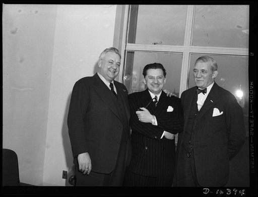 Washington, D.C. Opera singer Lauritz Melchior (left), and Gene (i.e., Jean) Hersholt, movie actor (center), visiting William Knudsen, director-general of the Office of Production Management (OPM)