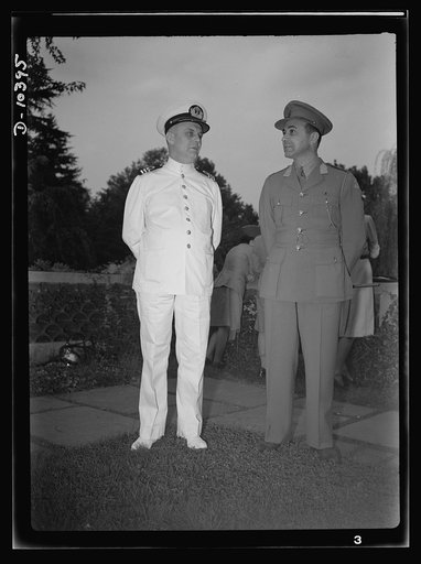 The uniforms are different but the cause is the same. Officers of the United Nations attend a garden party of the United Nations Club at Dumbarton Oaks, Sunday, September 6th, 1942. Left to right: Commander J. Blaauboer, Royal Dutch Navy Reserve, Assistant Naval Attache; Lieutenant W. Van der Weyde,