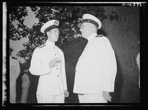 The uniforms are different but the cause is the same. Officers of the United Nations attend a garden party of the United Nations Club at Dumbarton Oaks, Sunday, September 6th, 1942. Left to right: Lieutenant Commander Y. C. Yang, China; Commander J. Blaauboer, Royal Dutch Navy Reserve, Assistant Nav