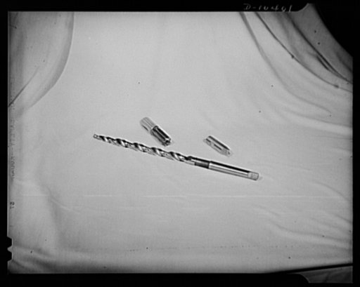 Top left: special end cutting form cutter. Top right: special forming tool. Bottom: long combination step drill and subland drill, nine and one-half inches long