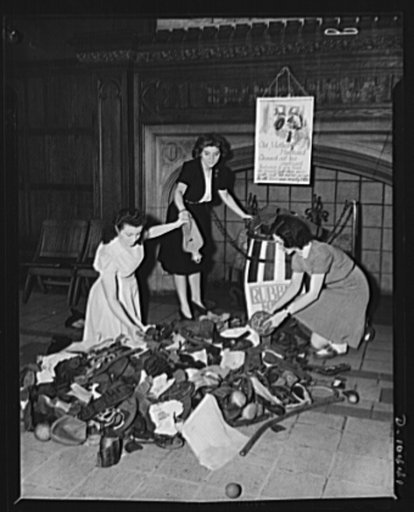 Scrap rubber drive at Washington Irving High School, New York City. Left to right: Susan Balint, Henrietta Morris and Ann Muzycka, seniors gathering in various rubber articles which students of the school found in their homes. Note in the background jingle dedicated to the national salvage drive