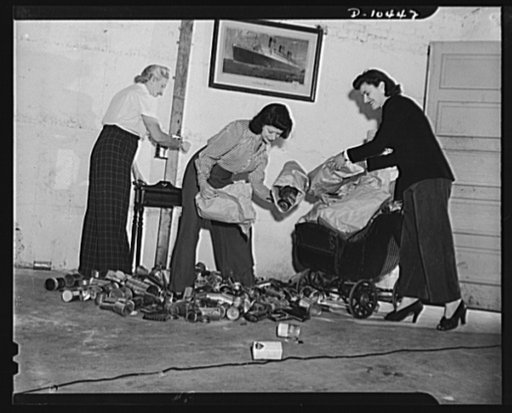 Scene in one of the basements of a Brooklyn apartment house with a squad of women volunteers at work on tin can salvage, organized by a Brooklyn housewife in the interest of the national war effort
