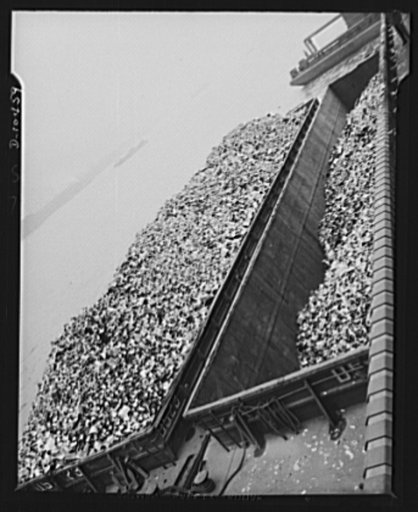 View of filled garbage scows holding 600 tons of empty tin cans collected over a period of two weeks in all the boroughs of the city of New York by Department of Sanitation trucks. Men of the department work on their own time to collect the critical war metal