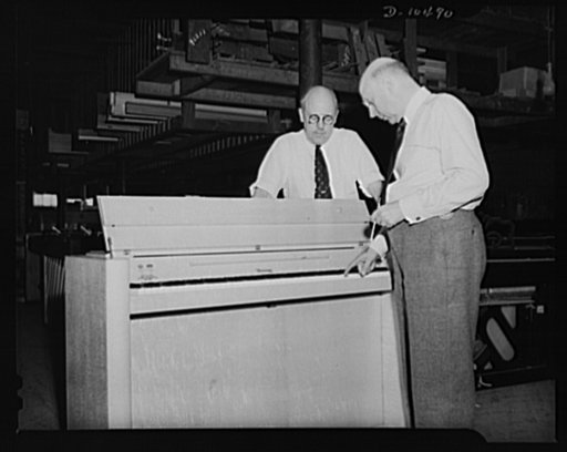 President and vice-president of "V-3" company test tone of newly completed blond maple piano
