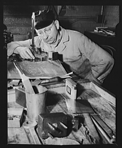 Tool maker inspecting finished carrier plates