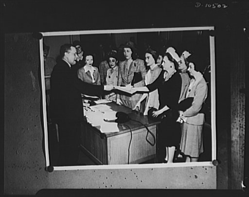 Office of Price Administration's (OPAA) Philadelphia enforcement attorney (no name available) hands out questionaires to volunteer women investigators in last weeks (week of June 7, 1942) drive to check price ceiling and rationing violations in test spots: New York, Newark and Philadelphia