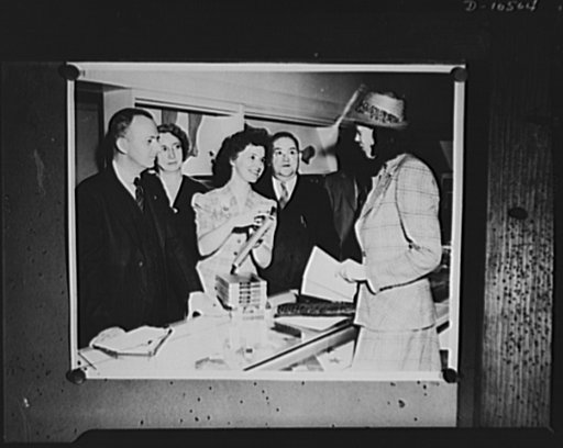 Posed photograph at a department store in Philadelphia, with volunteer woman investigator checking for Office of Price Administration's (OPA) enforcement agency prices of lingerie and hosiery