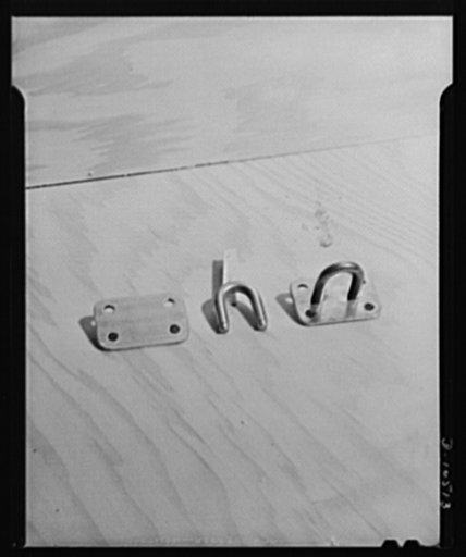 Bits and pieces. Template with cornerholes punched; staple machined and formed; completed hasp