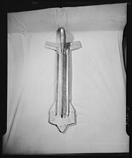 The parts shown are aluminum supports for plane wings. These are made under subcontract by a small New York manufacturing plant