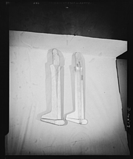 The parts shown are aluminum supports for plane wings. These are made under subcontract by a small New York manufacturing plant