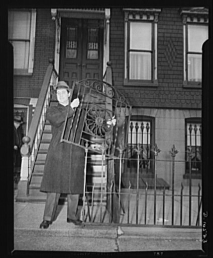 "V" Gates, Hitler. Jack Nathan, holds the grill from his Brooklyn home, which he donated yesterday to the New York City Salvage Committee to help its campaign for scrap metal