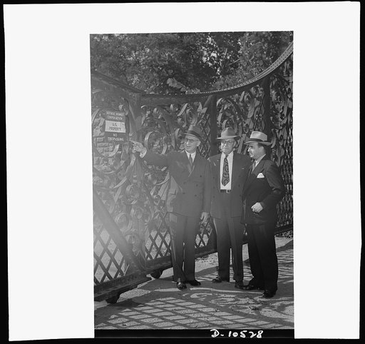 Old gates turned in for scrap. Inspecting the gates of the old McLean Mansion, now government property, which are to be torn down for scrap. Left to right: Lessing J. Rosenwald, director, War Production Board (WPB) Conservation Division; Robert C. Waldie, project manager, Defense Homes Corporation; 