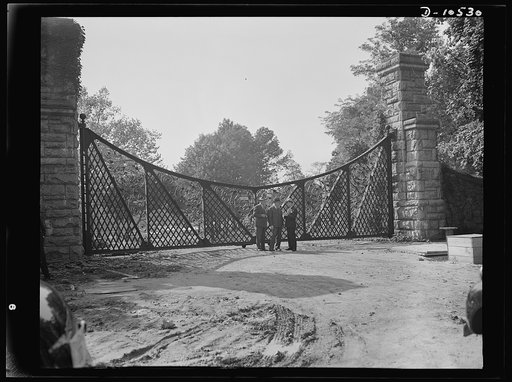 Old gates turned in for scrap. Soon to be added to the scrap pile is this huge wrought iron gate of the historic Friendship estate, Washington, D.C., which the government has taken over for a huge housing project. This is one of two large gates of the estate, which, along with a 400-foot iron fence,