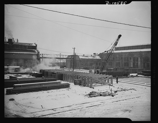 Denver, Colorado. Piles of steel plate and steel beams, from Pennsylvania in a converted railroad yard where they are being "pickled" and prepared for intricate fabrication into ship parts, to be sent eventually to Mare Island for assembly into escort vessels