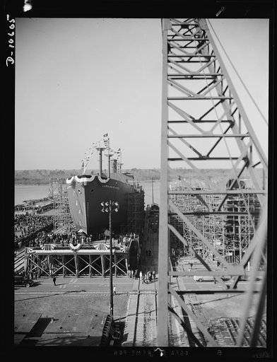 Launching of 10,000 ton ships. The first of 90 sister ships to be built for the Maritime Commission slides off the dock into the Atlantic. Launched just one year from the time construction work started on the shipyards, this 10,000 ton vessel is of the "Virginia Dare" type. In the future these ships