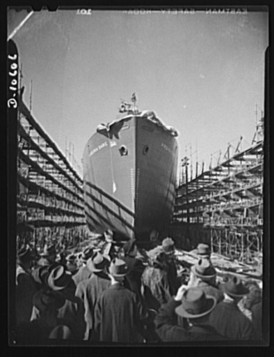The launching of a 10,000 ton ship. Soon, one a week like this! The third 10,000 ton vessel to be launched from new shipyard on the East coast slides down the ways into the water. From the present one-every-two-weeks schedule, these "Virginia Dare" type vessels will shortly be produced at double spe