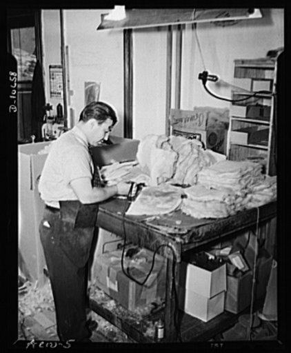 Aero Leather Coat Company, Inc. Clipping excess wool along seam edge