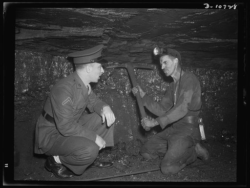 War production drive. Anthracite rallies. A soldier is shown how a miner swings a pick under a low ceiling in a Pennsylvania anthracite mine. Soldiers, sailors and miners attended the anthracite miners' rallies in Scranton, Wilkes-Barre, Hazleton and Mount Carmel, Pennsylvania, September 28th throug