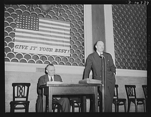 Frank C. Wright, Jr., Washington representative for the anthracite industry, speaking before labor-management committee members at Scranton, July 29th. Michael J. Kosik, seated.