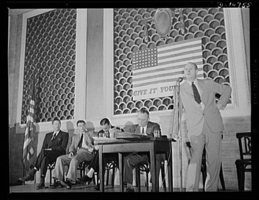 Alex G. Nordholm, Chief, Regional Service, War Production Drive Headquarters, speaking before labor-management committee members at Scranton, July 29th. Seated, left to right: Earl Schenck, Naval Consultant; Earl Williams, tanker sailor; Dmitri Goulandris, torpedoed sailor; Michael J. Kosik