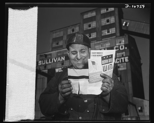 War production drive. Anthracite rallies. Smiling with pleasure, a husky coal miner reads the enclosure with his pay check that shows him how he is helping to win the war. He extracts anthracite, or hard coal, from an Eastern Pennsylvania mine