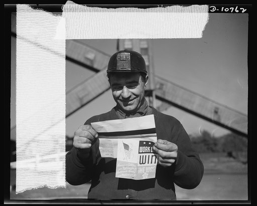 War production drive. Anthracite rallies. Smiling with pleasure, a coal miner reads the paycheck enclosure which explains the importance to the war effort of all-out production. He extracts anthracite, or hard coal, from an Eastern Pennsylvania mine