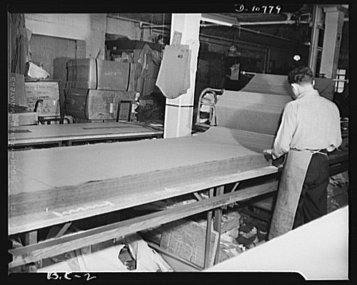 Best Coat and Apron Manufacturing Company. Spreading herringbone twill on cutting table