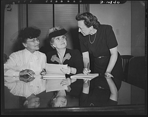 The first meeting of the women's policy committee of War Manpower Commission (WMC) on Oct. 1, 1942. Thre members get acquainted. Left to right: Maudell Bousfield, Margaret A. Hickey, chairman, and Sue Southall. The committee was formed to aid in mobilizing women war workers for the war effort