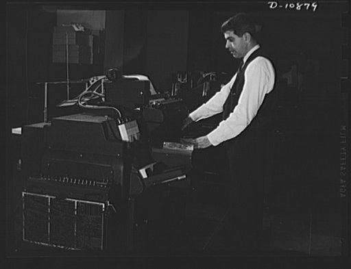 ODT system of port control. Operator Jack Keefe, in the International Businees Machine (IBM) room of the ODT (Office of Defense Transportation), feeds the coded punched cards into the machine which records and tabulates by channel, section, zone and individual railroad the movement of all freight tr