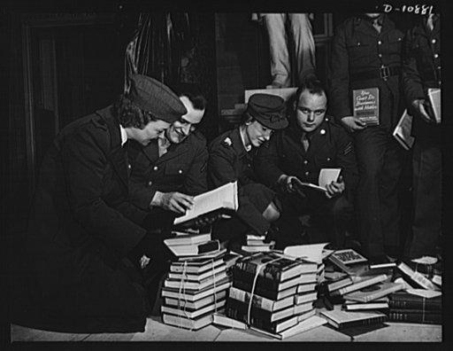Victory Book Campaign. Soldiers of Fort Myer, Virginia, and volunteer members of the Red Cross examine books in Statuary Hall of the Capitol during ceremonies in which members of Congress contributed to the 1943 Victory Book Campaign