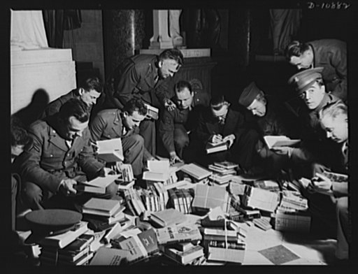 Victory Book Campaign. Soldiers of Fort Myer, Virginia, in Statuary Hall of the Capitol, receiving books donated by members of Congress for 1943 Victory Book Campaign