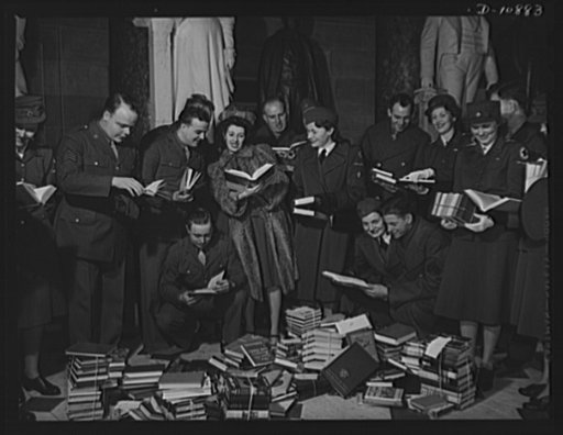 Victory Book Campaign. Soldiers of Ft. Myer, Virginia, and members of the American Red Cross Volunteer Service examine books contributed by members of Congress for the 1943 Victory Book Campaign