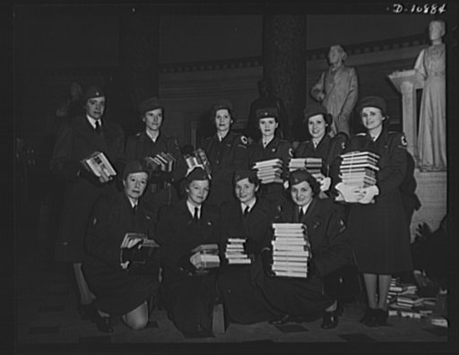 Victory Book Campaign. Volunteer members of the Red Cross display books contributed by members of Congress for 1943 Victory Book Campaign at ceremonies in Statuary Hall in the Capitol